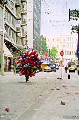 Whether this balloon-guy was up early - or late to bed - I'm not sure about. But the picture is taken on Ermou early sunday morning. It's the greek parliement in the background.